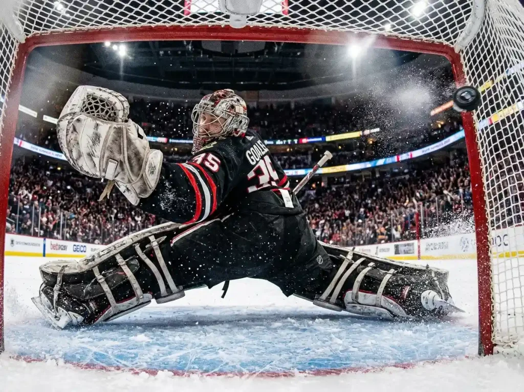 NHL goalie reaching across the crease during a high-scoring game