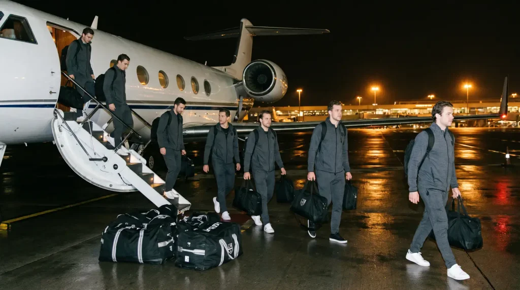 NHL team disembarking from a charter flight at night for a back-to-back road game
